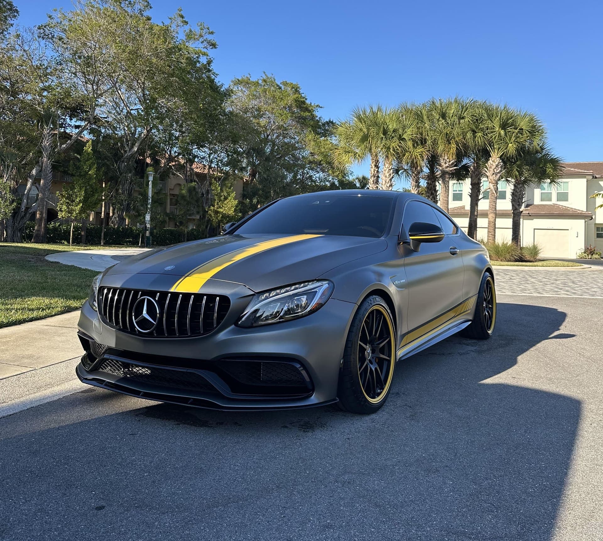 Matte gray Mercedes-AMG C63 coupe with a gold stripe after a Moretti Bros detail